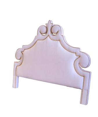 Pink upholstered headboard with decorative trim.