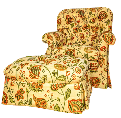 Floral upholstered armchair and ottoman. Beige background with green and orange flower pattern.