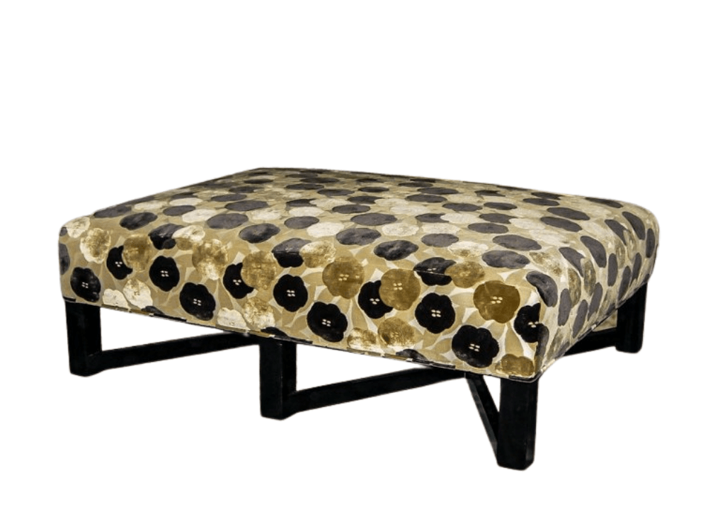Square ottoman with black legs and floral patterned upholstery.