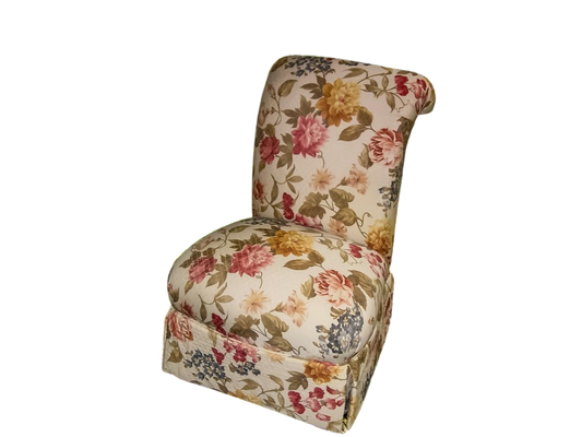 Upholstered chair with floral pattern, ivory background, pink, yellow, and blue flowers.