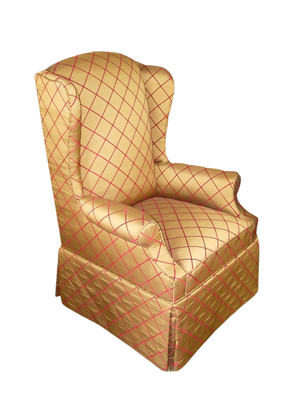 Gold wingback chair with red diamond pattern.