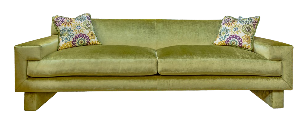 A green velvet sofa with two patterned pillows on a white background.