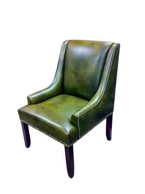 Green leather armchair with dark wood legs and studded trim.