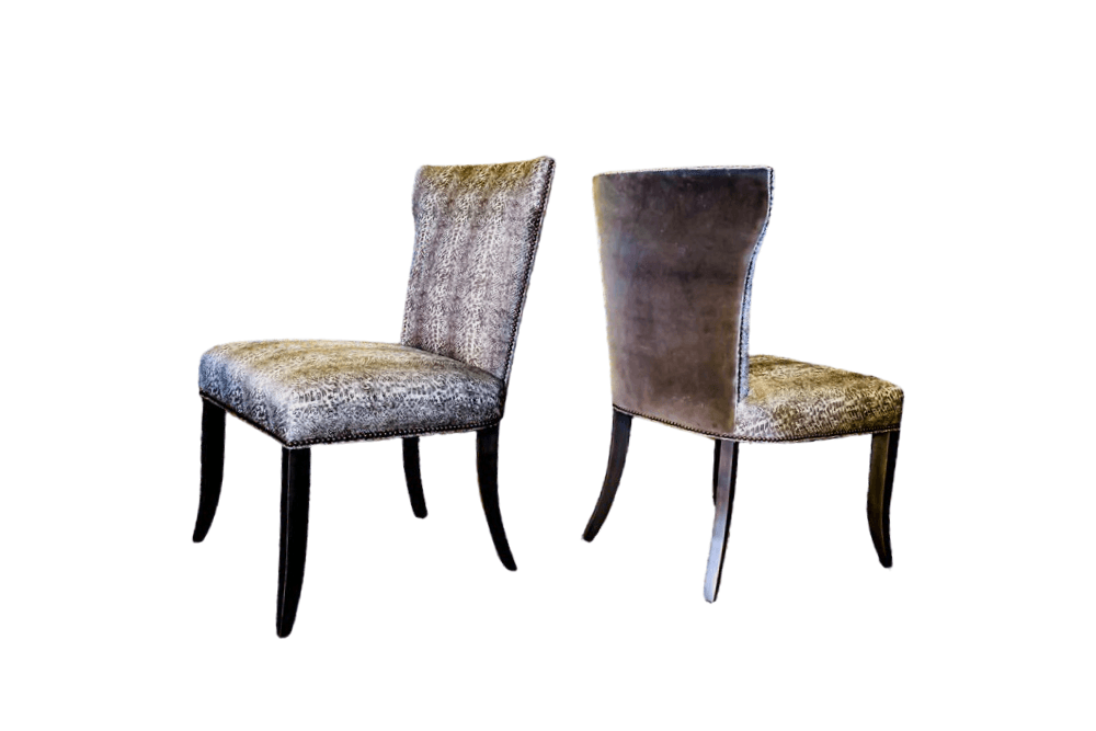 Two upholstered dining chairs with dark wood legs, one facing forward, one facing back.