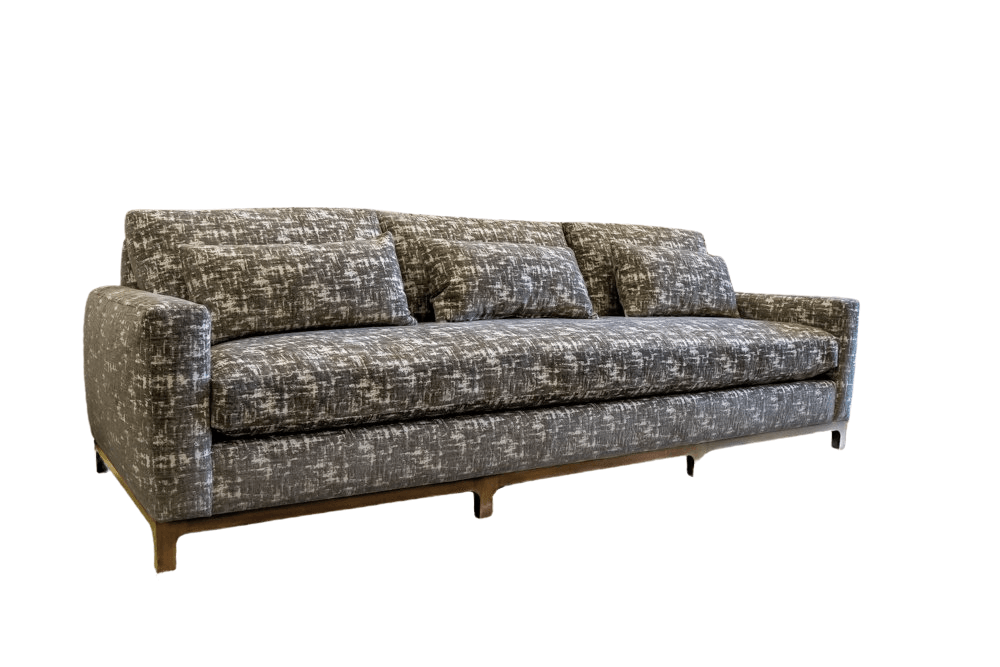 Gray patterned sofa with three back cushions.