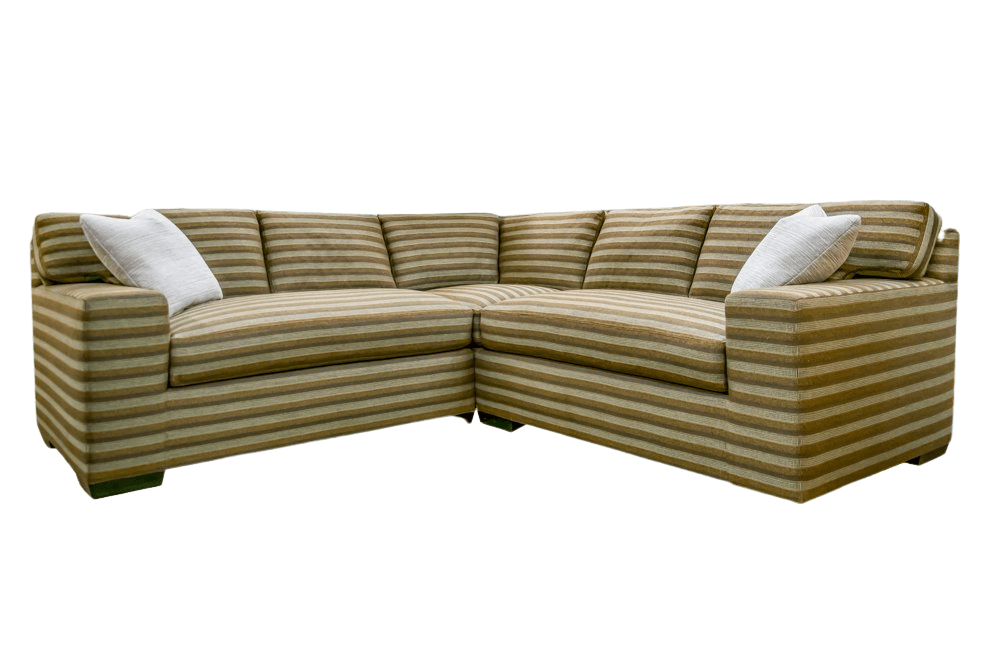 Beige and white striped sectional sofa with two white throw pillows.