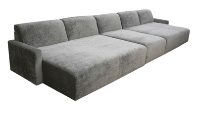 Gray modular sofa with multiple sections on a white background.