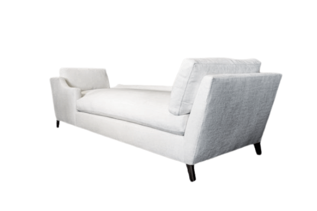 White upholstered chaise lounge with angled arms and dark legs.