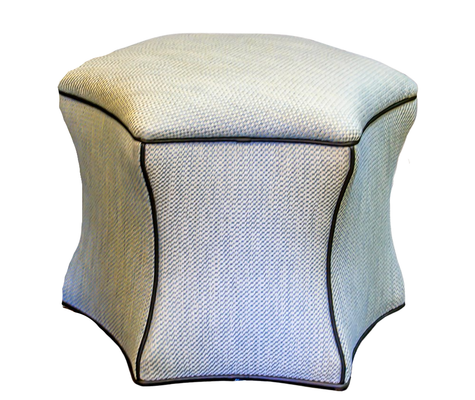 Upholstered, square ottoman with curved sides, light fabric, dark piping.