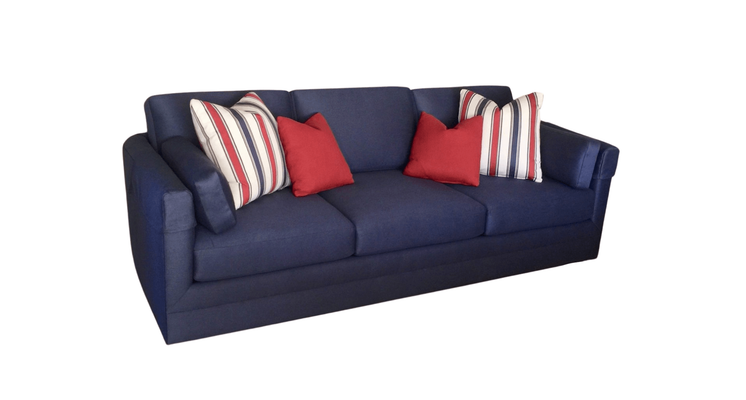 Navy blue sofa with red and striped pillows.