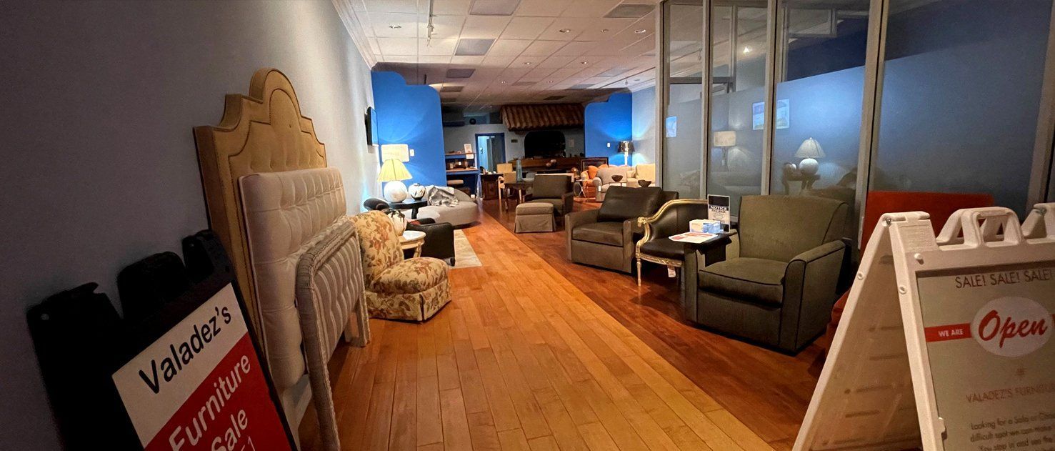 Interior of a furniture store, with sofas and chairs on display and an