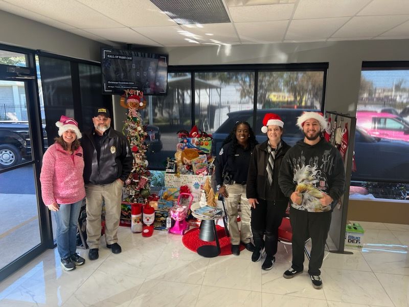 High Line Service & Repair Team with Santa hats near a Christmas tree | High Line Service & Repair