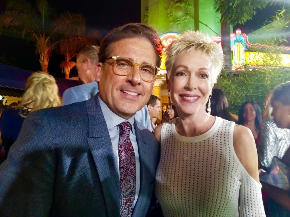 A man and a woman are posing for a picture at a party.