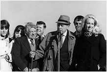 A group of people are standing next to each other in a black and white photo.