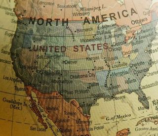 A vintage map of North America, showing Canada, the United States, and Mexico in muted tones.