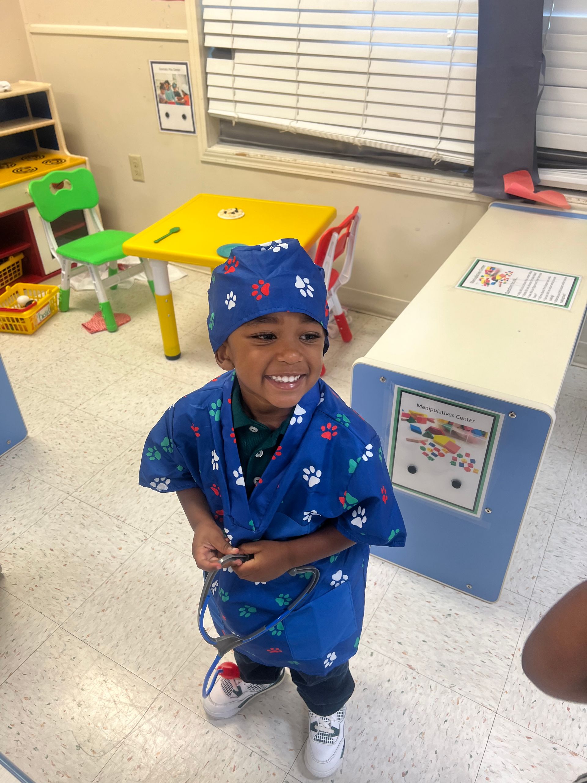 A group of children are sitting in a yellow toy car.
