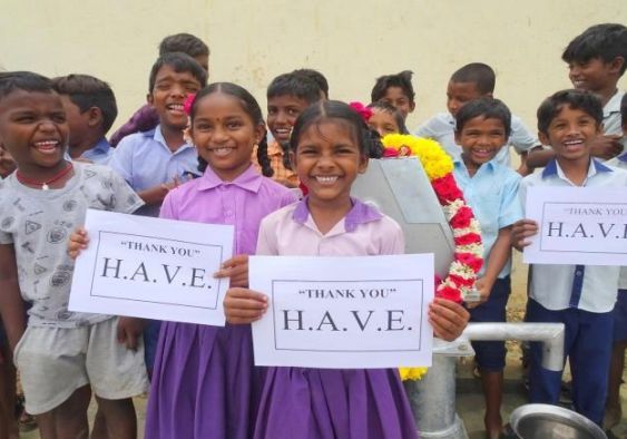 Children smiling, holding 