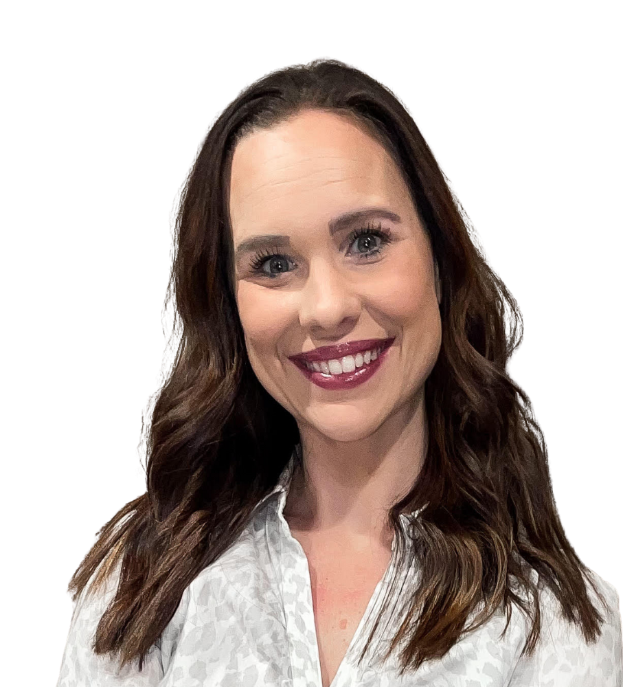 A woman with long brown hair is smiling and wearing a white shirt.