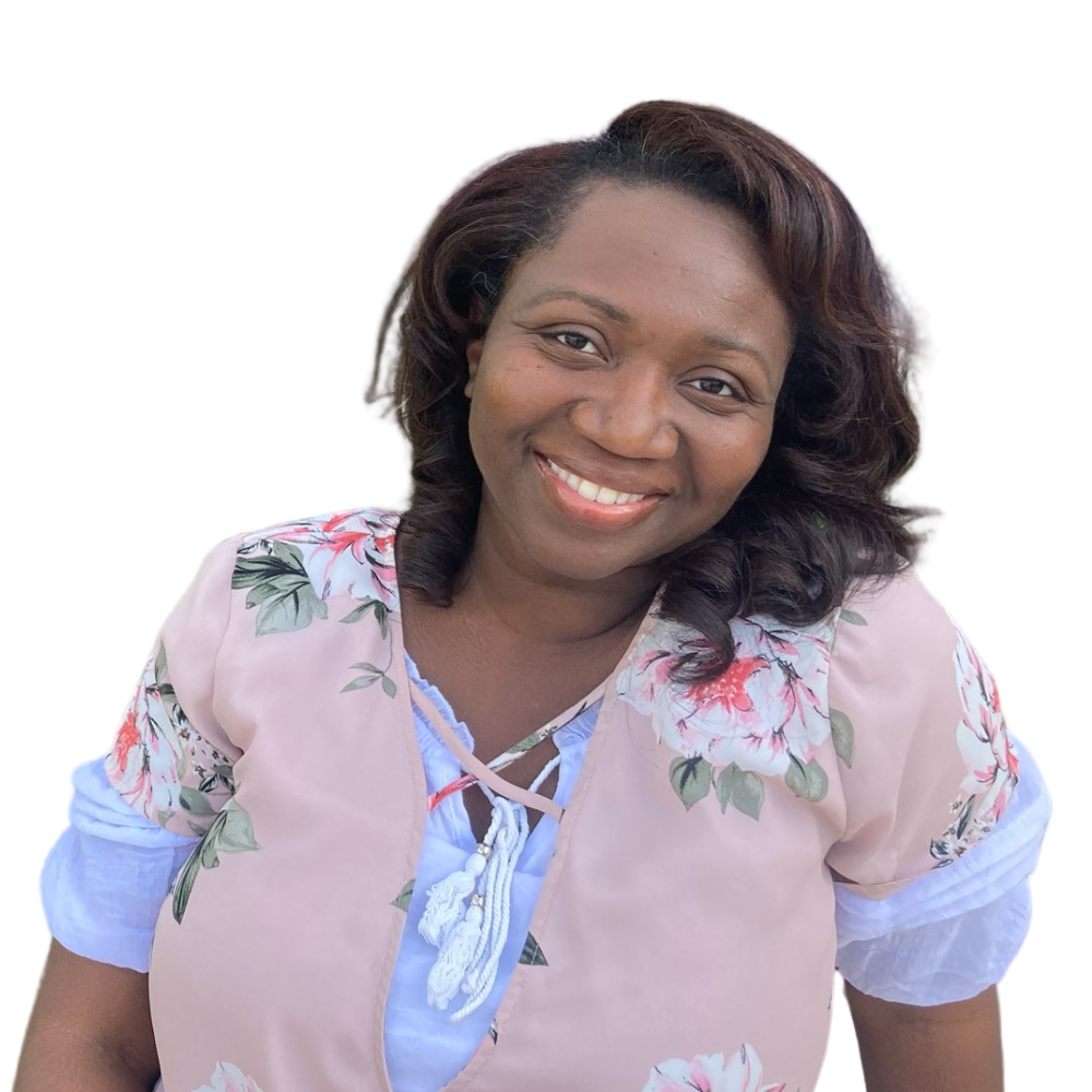 A woman in a pink floral shirt is smiling for the camera.