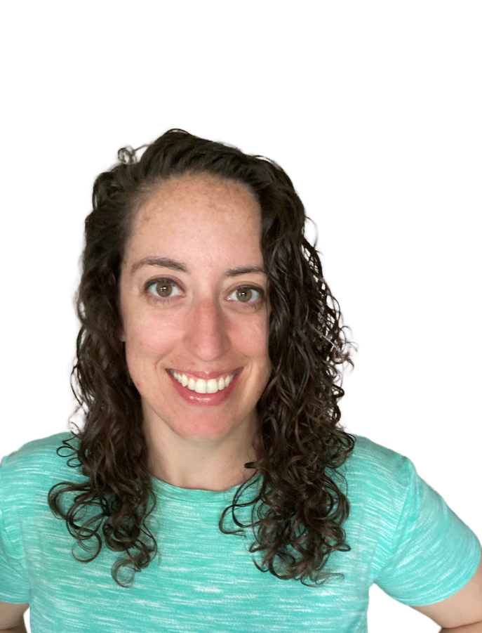 A woman with curly hair is wearing a green shirt and smiling.