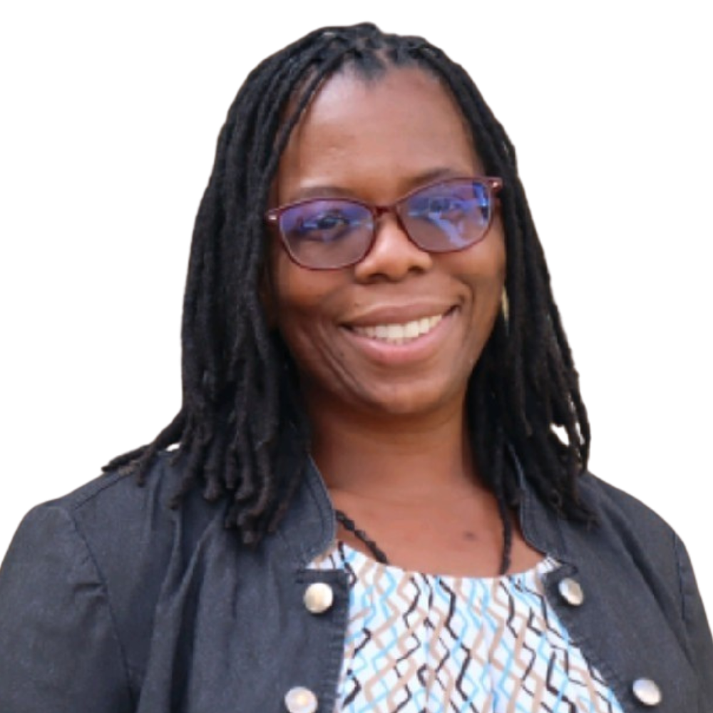 A woman with dreadlocks and glasses is smiling for the camera