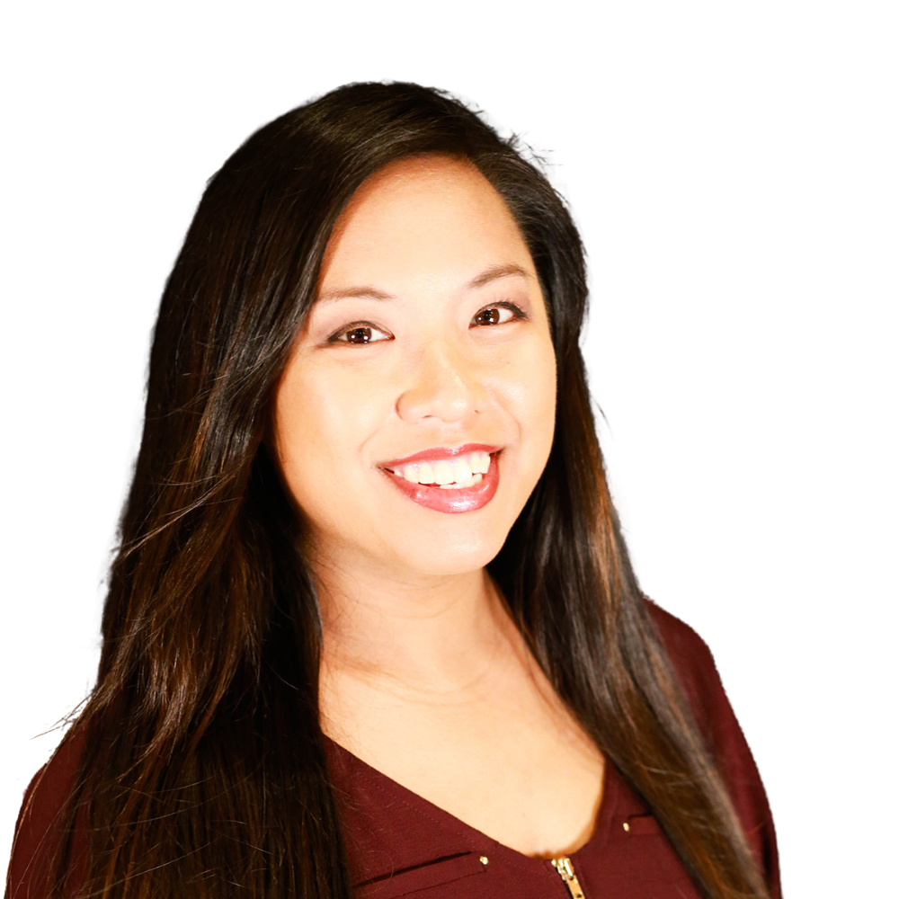 A woman with long hair is smiling and wearing a maroon shirt