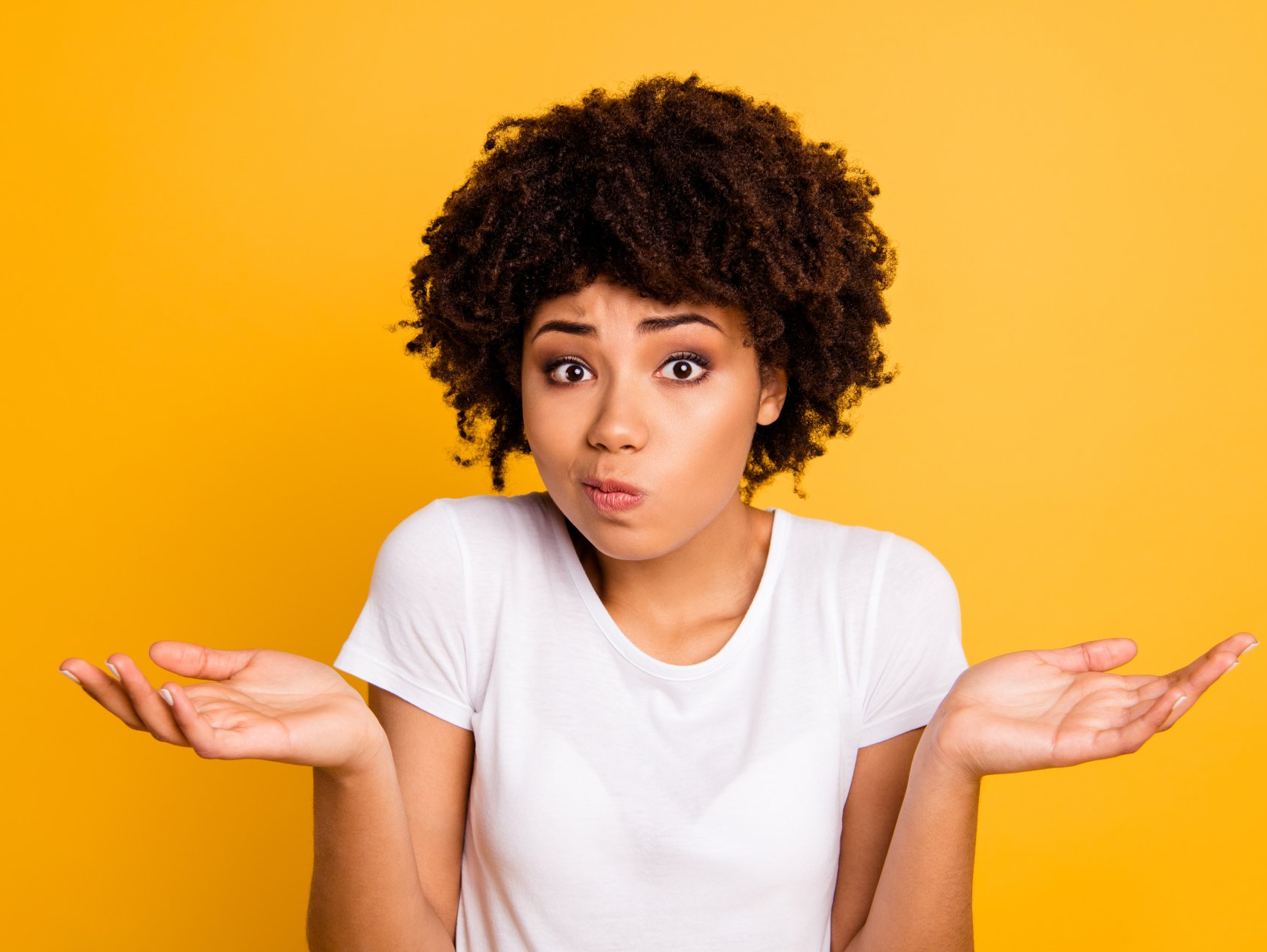 woman with hands up confused