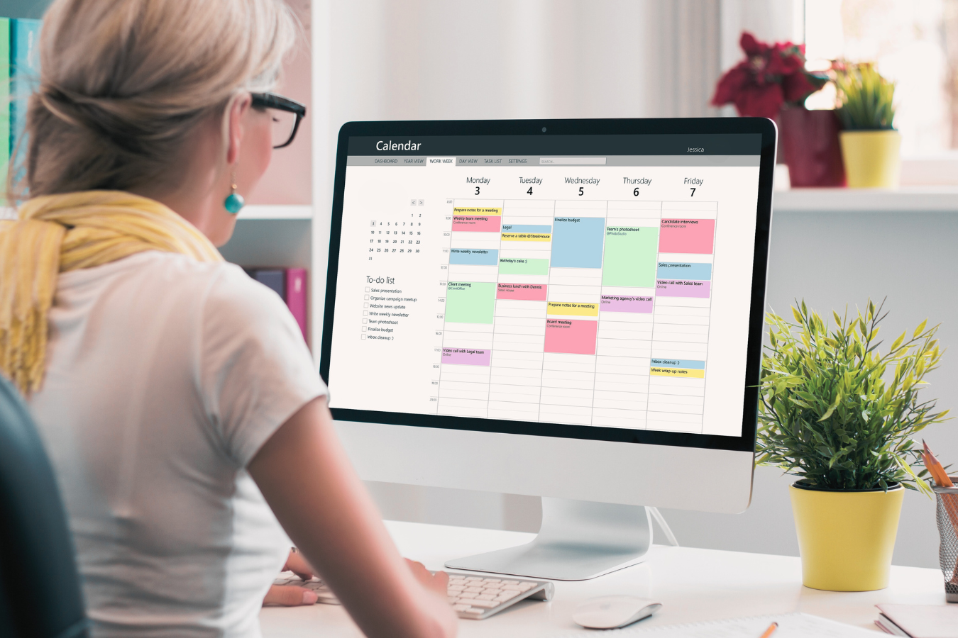 A woman manages a digital calendar from her home computer. | Freedom Makers