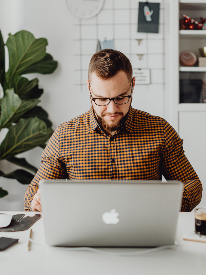 Small business owner on his computer outsources support projects.