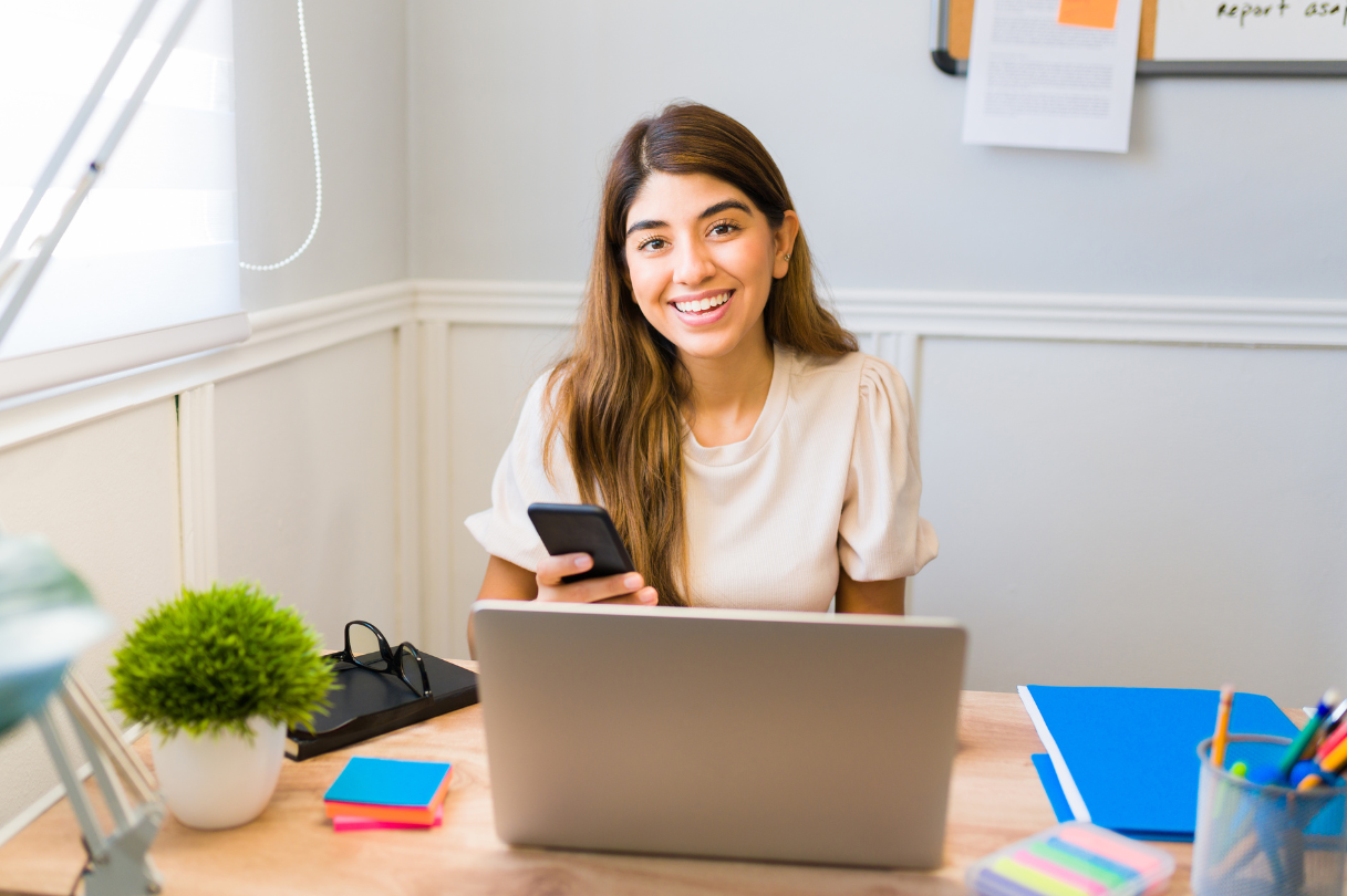 A dark haird woman works at her home office