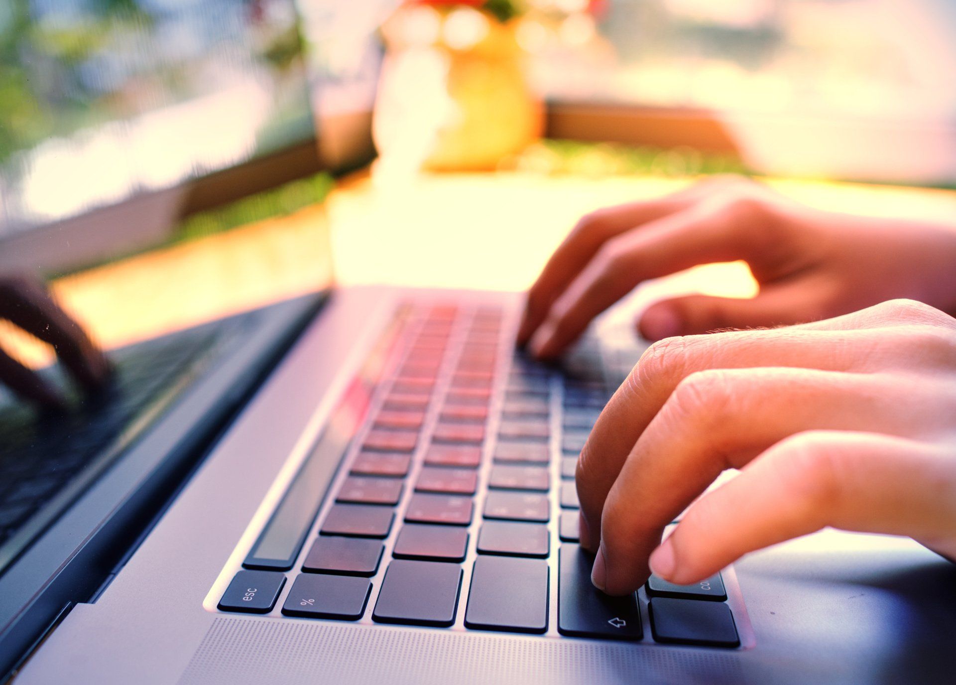 A person is typing on a laptop computer.