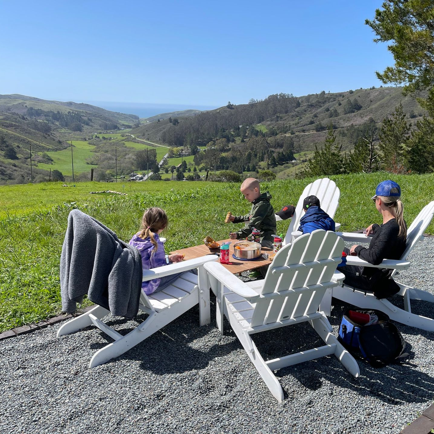 a family enjoys a meal overlooking a beautiful valley on Mooncrest Valley Ranch's property