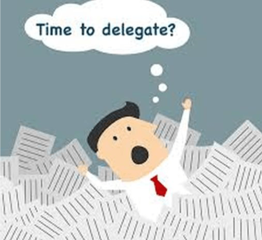 A cartoon of a man in a pile of papers with the words time to delegate above him