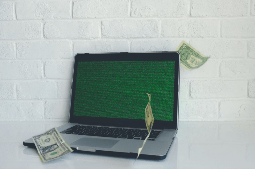 laptop with money on it