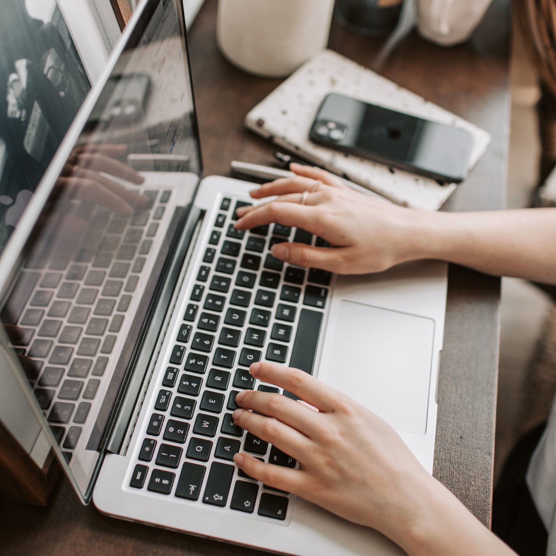 A person is typing on a laptop computer.