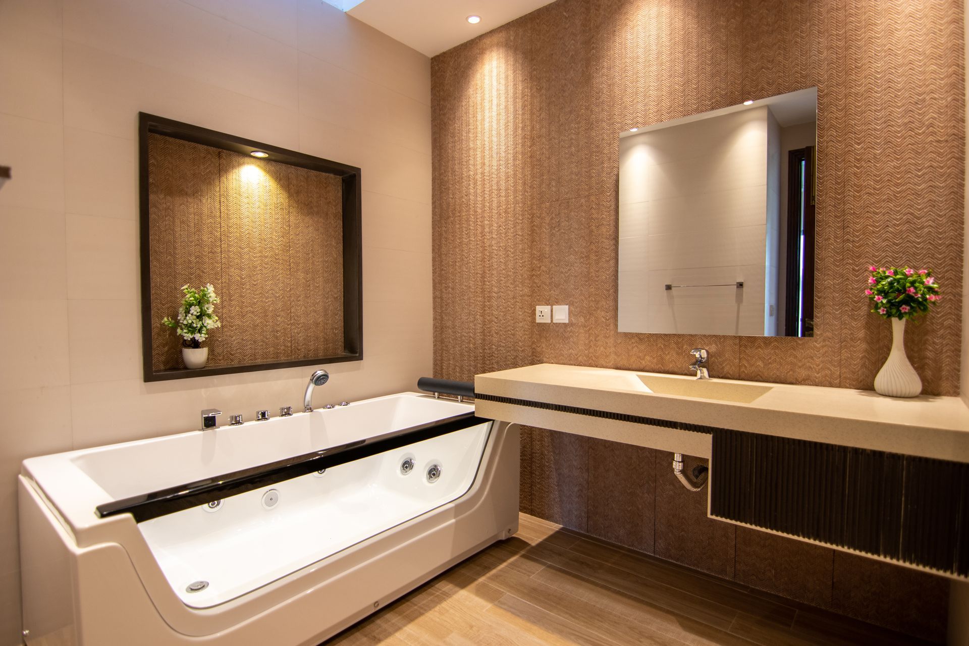 A bathroom with a bathtub , sink and mirror.