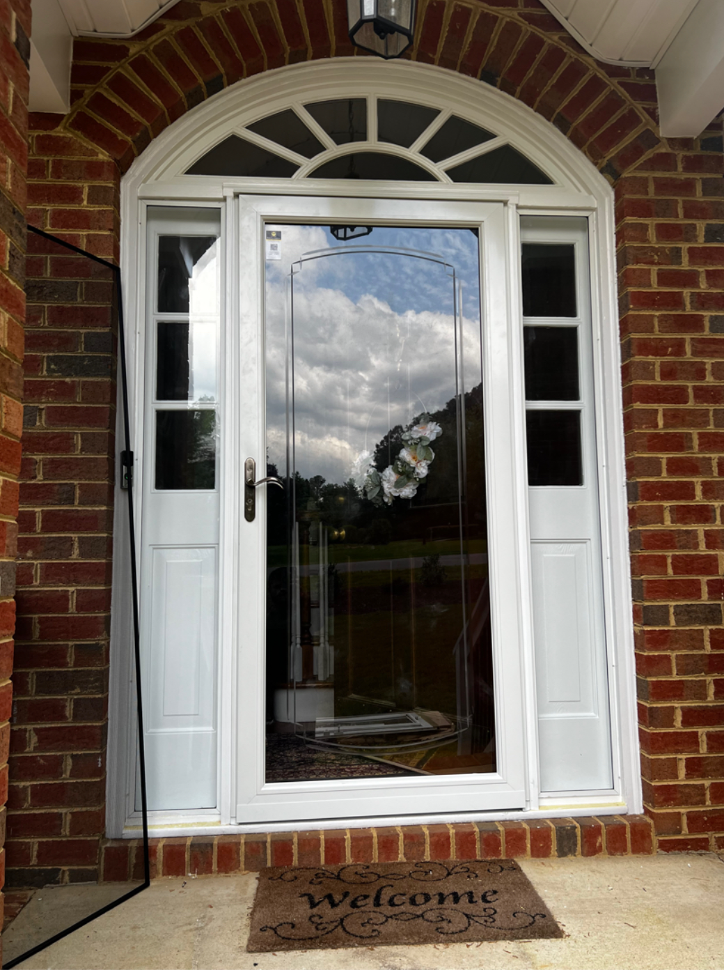 A white door with a welcome mat in front of it