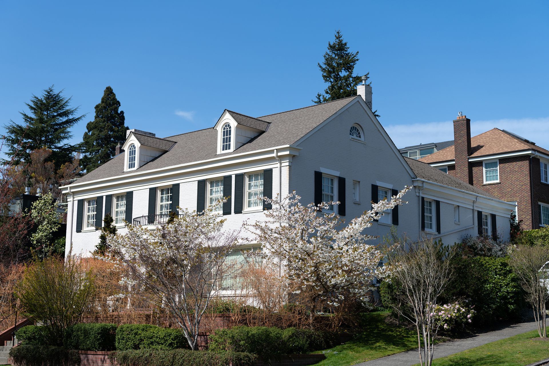 A large white house with black shutters on the windows
