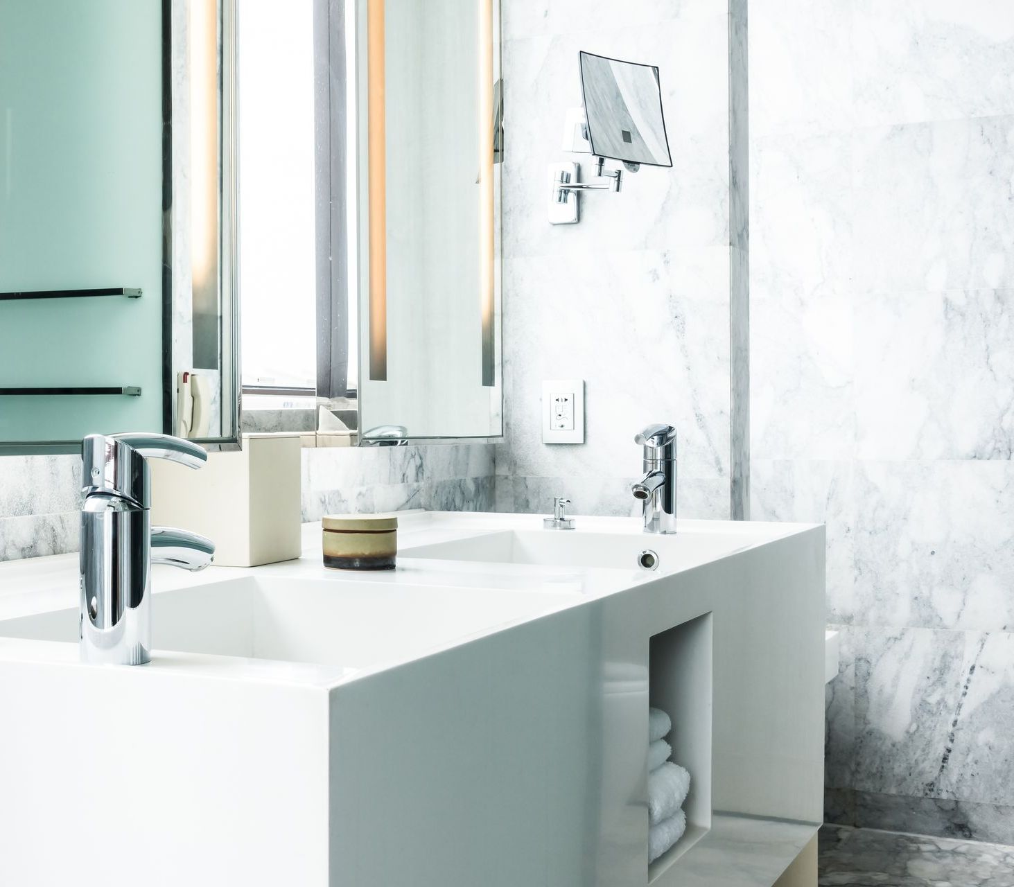 A bathroom with a sink , mirror and faucet.