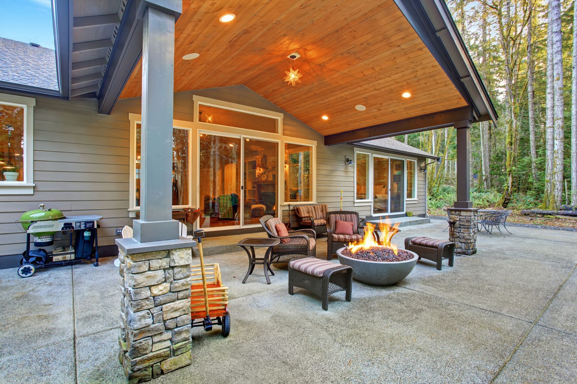 There is a fire pit on the patio of a house.
