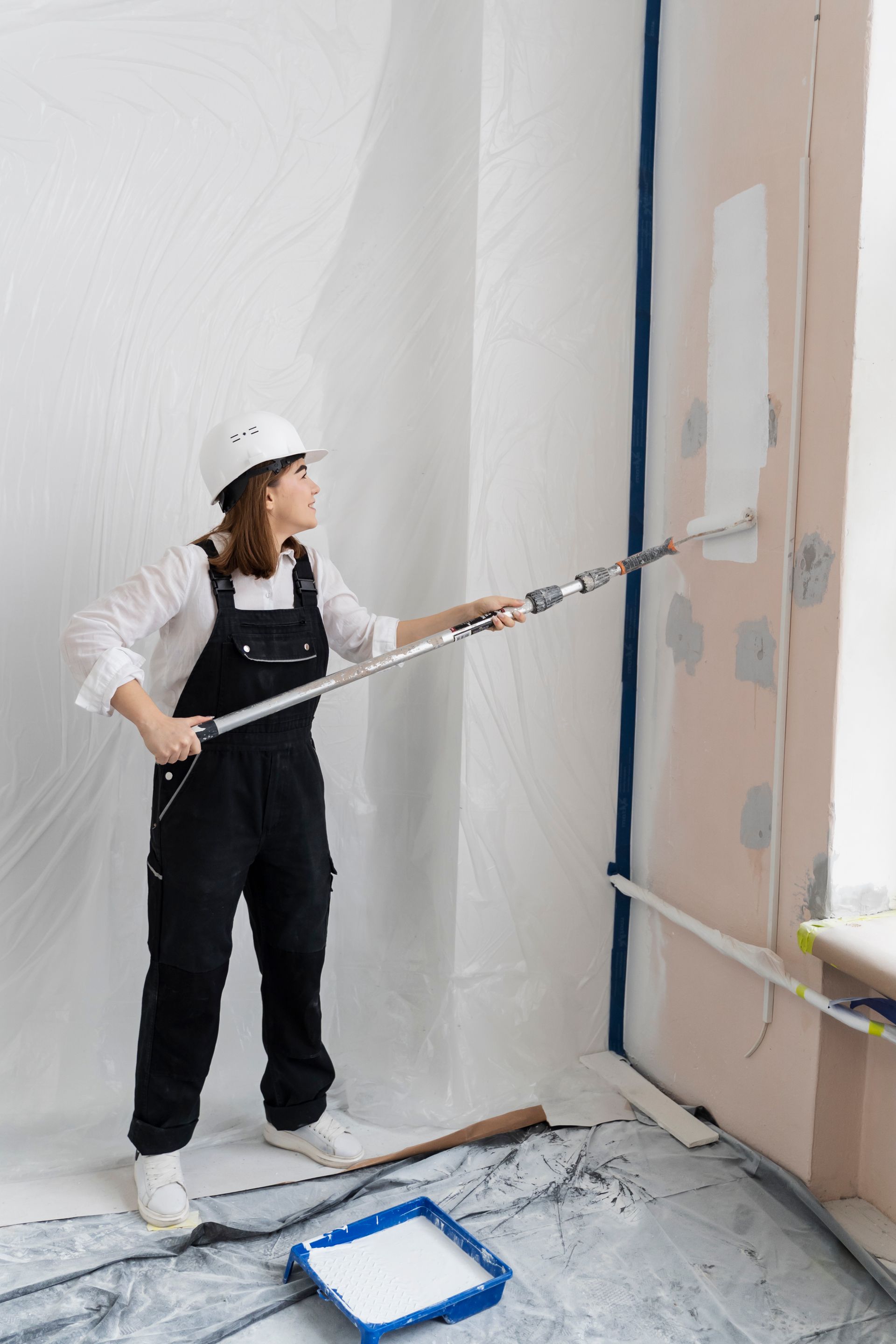 woman painting house wall