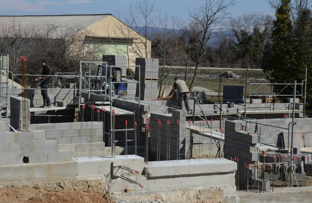 A construction site with a building in the background