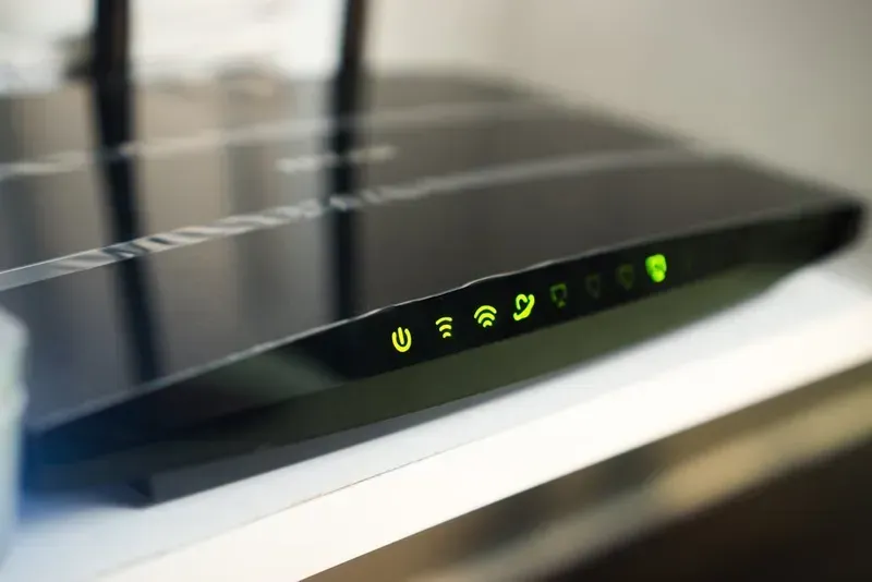 Black Wireless Router With Illuminated Green Status Lights — Superior Wifi in Ballina, NSW