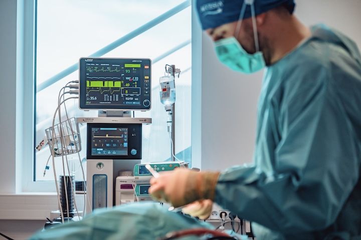 Un chirurgien opère un patient dans une salle d'opération.