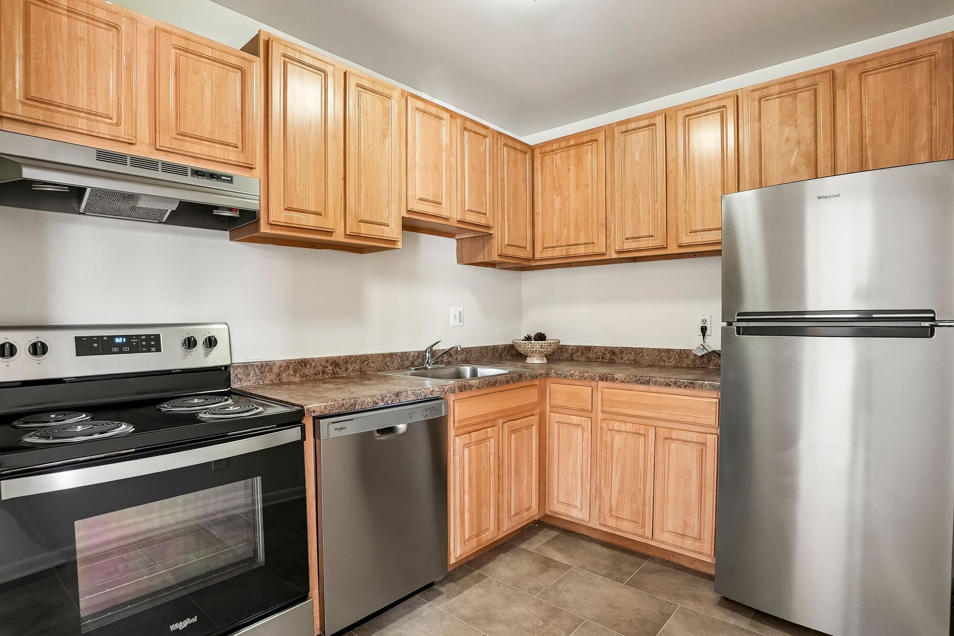 Kitchen with wood cabinets and stainless steel appliances at Westover Pointe in Wilmington, DE.