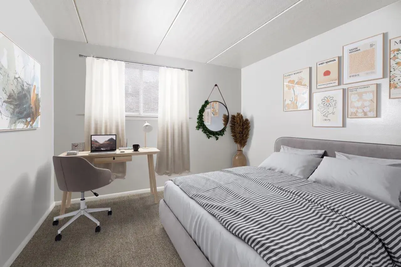 Bedroom with a bed, desk, chair, window with sheer curtains, and wall art at Westover Pointe in Wilmington, DE.