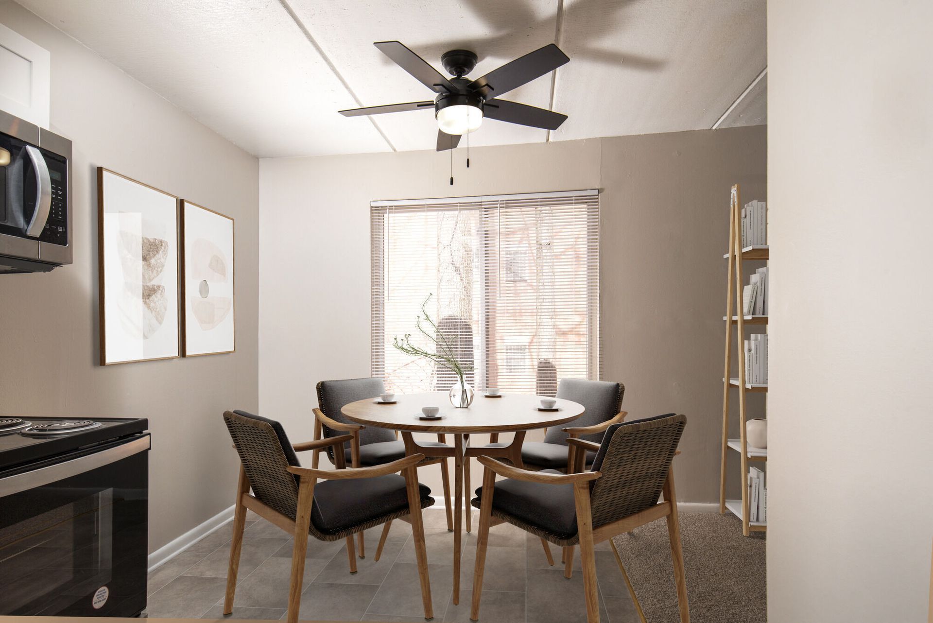 Dining area with round table, six chairs, window blinds, and a ceiling fan in an apartment at Westover Pointe in Wilmington, DE.