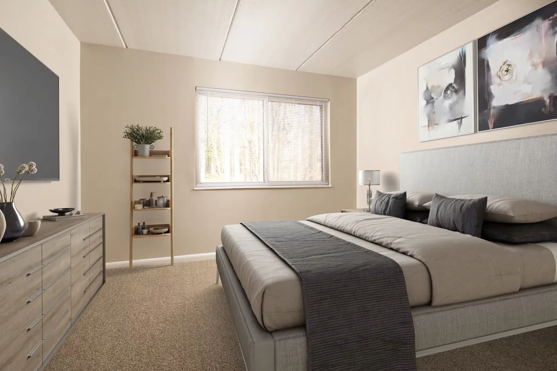 Bedroom in an apartment with a large bed, dresser, and a window with blinds at Westover Pointe in Wilmington, DE.