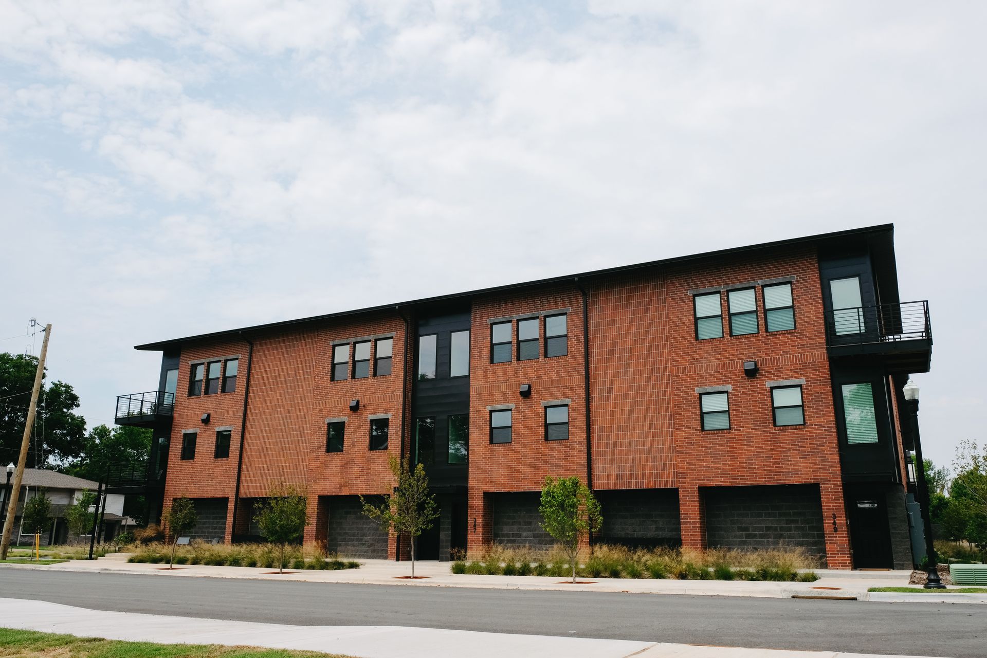 A large brick building with a lot of windows and garages