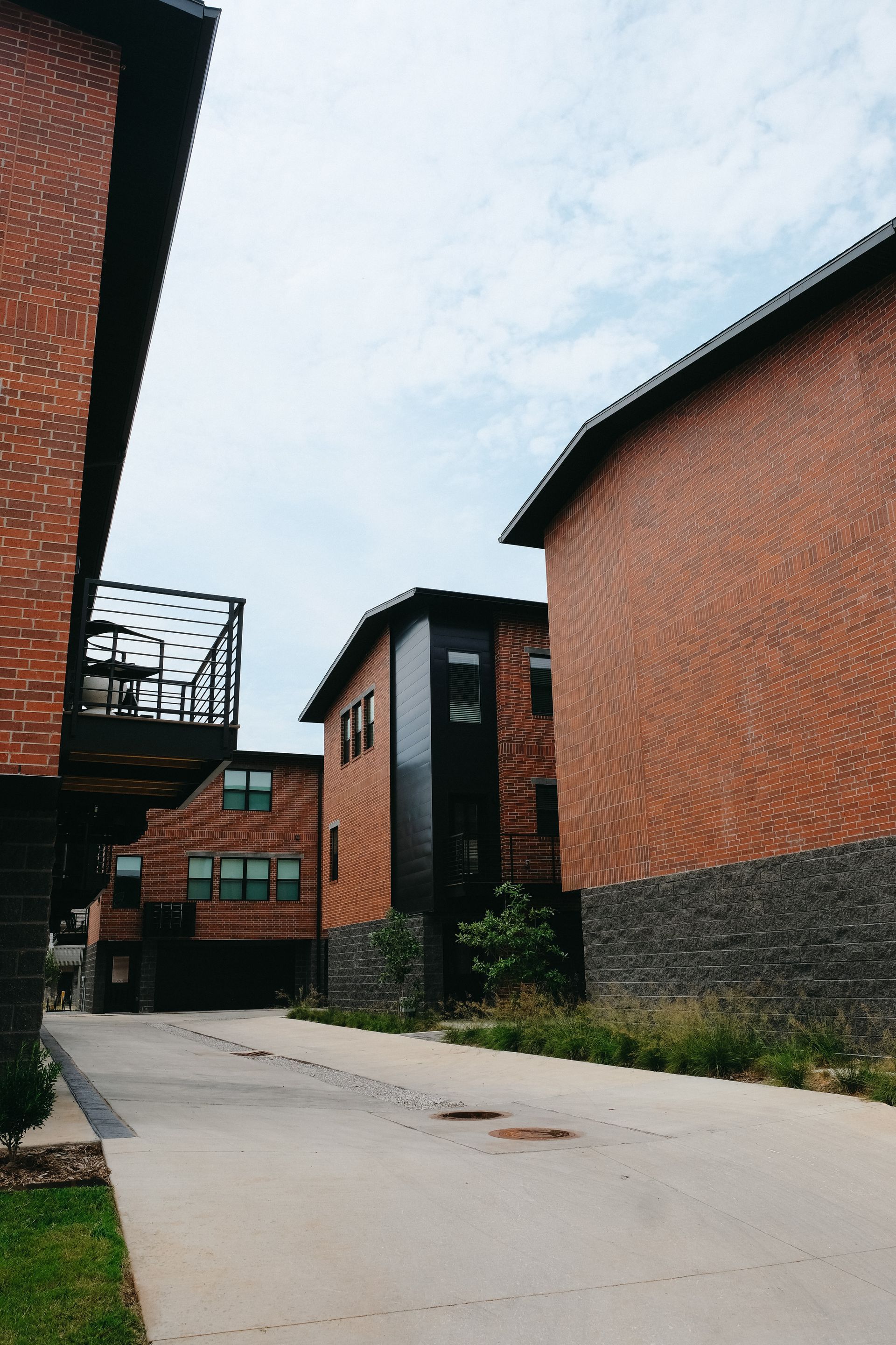 A row of brick buildings are lined up next to each other on a street.